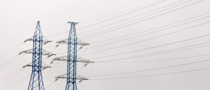 Blue high Pylon high-voltage power lines, high voltage electric transmission tower for producing electricity at high voltage electricity poles at the sunset.