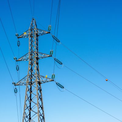 A high voltage post on a blue background