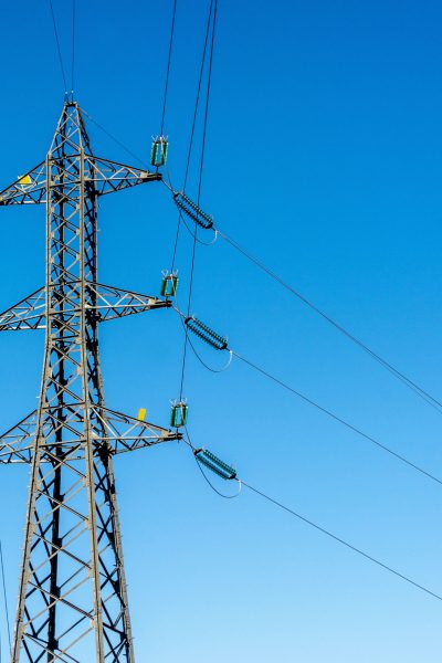 A high voltage post on a blue background