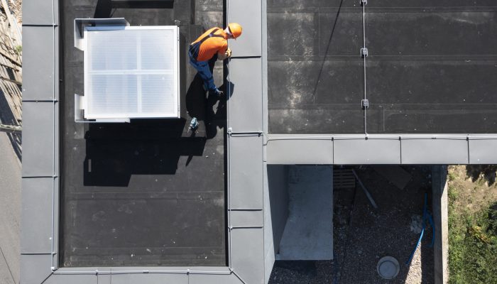 Lightning Protection Rod Installation on Top of a Building. Professional Worker Finishing Installation.